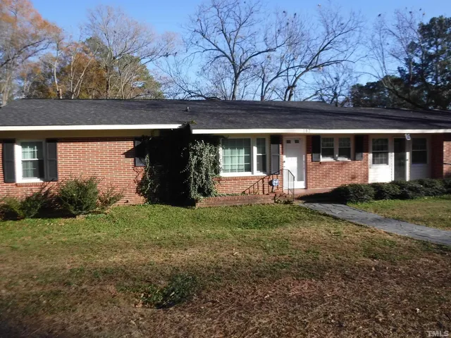 a view of house with backyard