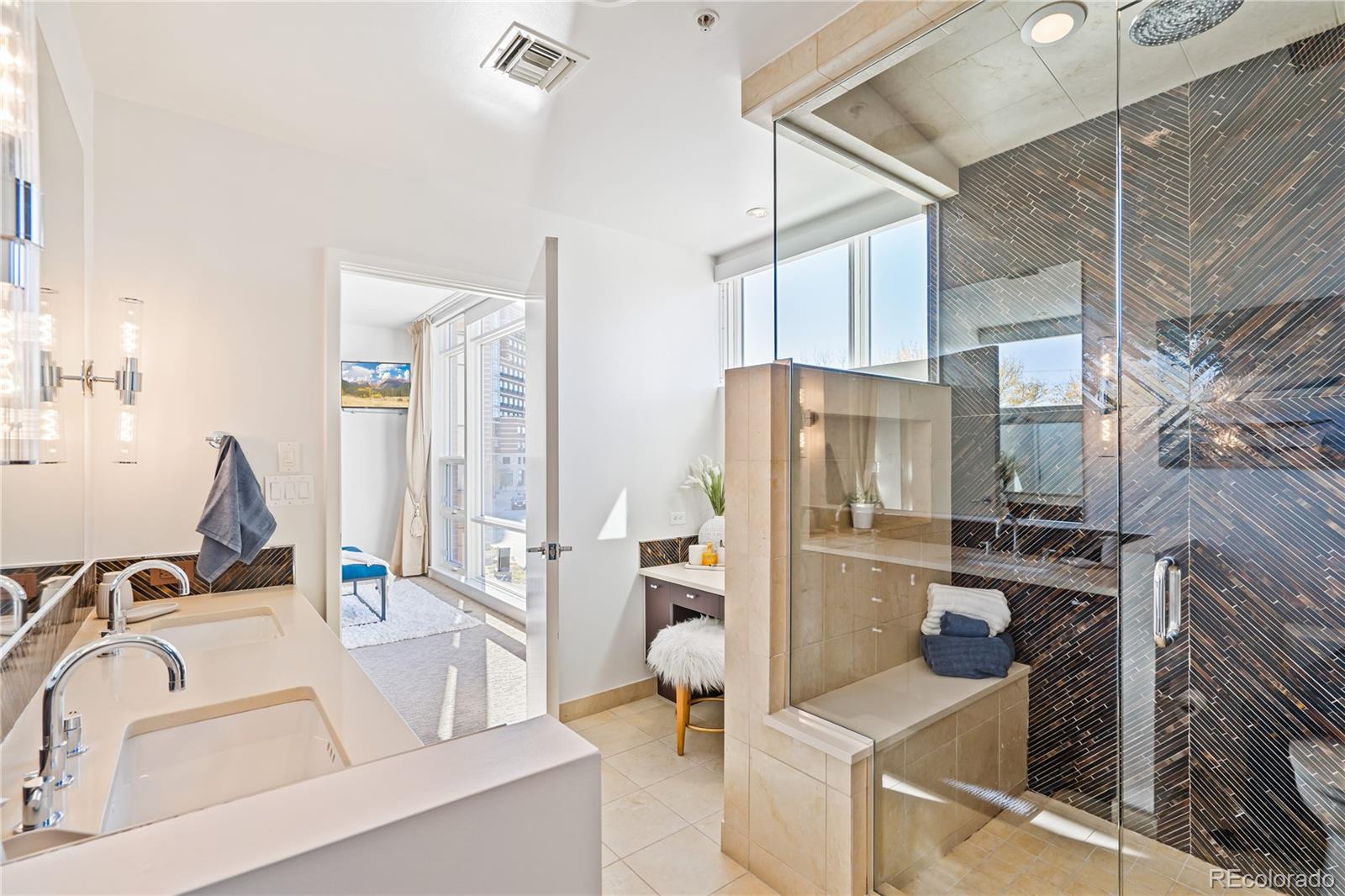 1640 Little Raven Street Denver, CO 80202 - Photo 31 of 47 a kitchen with stainless steel appliances kitchen island granite countertop a refrigerator and a sink
