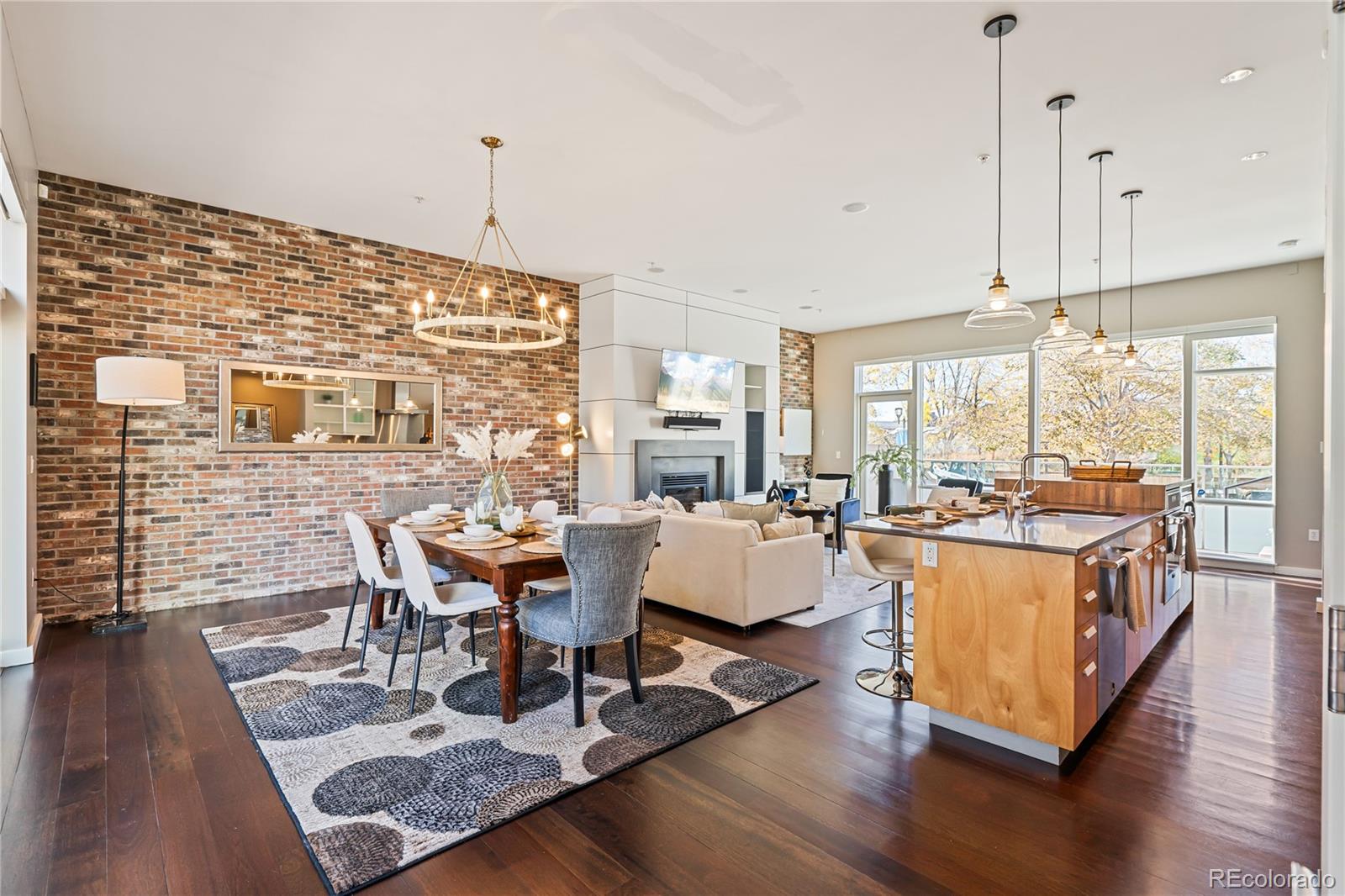 1640 Little Raven Street Denver, CO 80202 - Photo 5 of 47 a living room with fireplace furniture wooden floor and a table