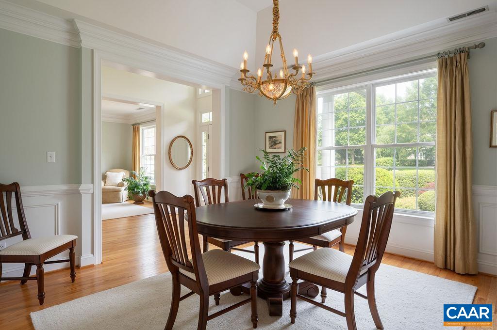 3515 Devon Pines Keswick, VA 22947 - Photo 13 of 68 a view of a dining room with furniture a chandelier and wooden floor
