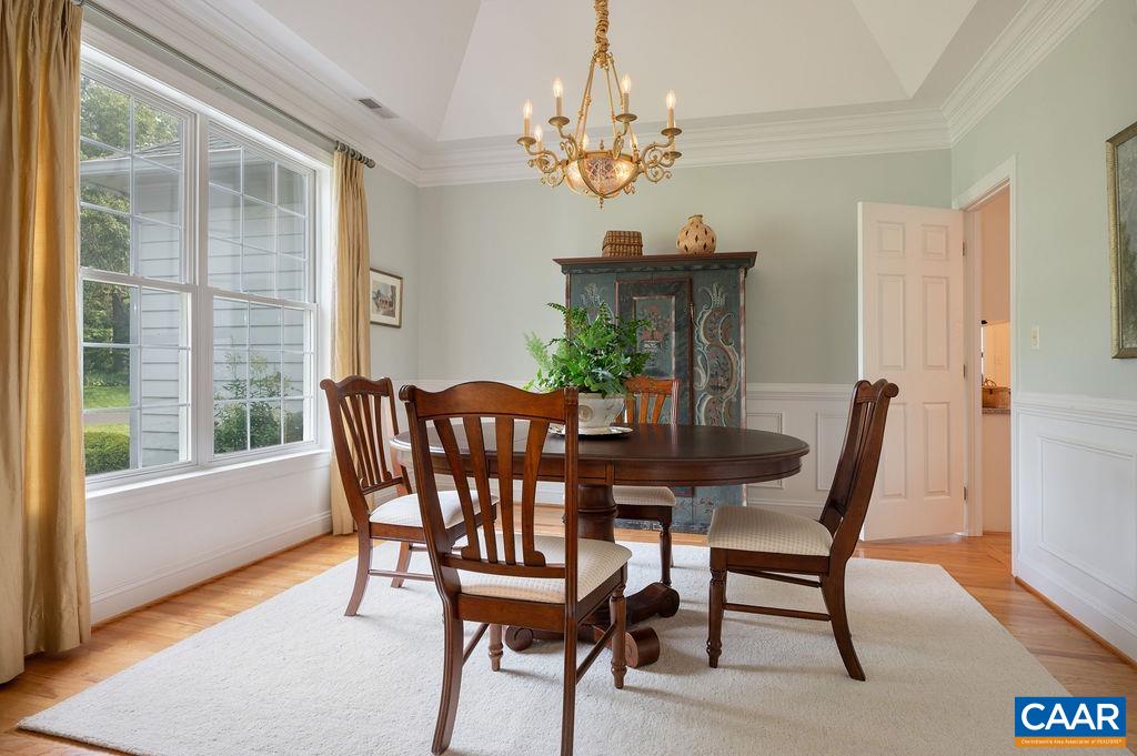 3515 Devon Pines Keswick, VA 22947 - Photo 15 of 68 a view of a dining room with furniture a chandelier and wooden floor