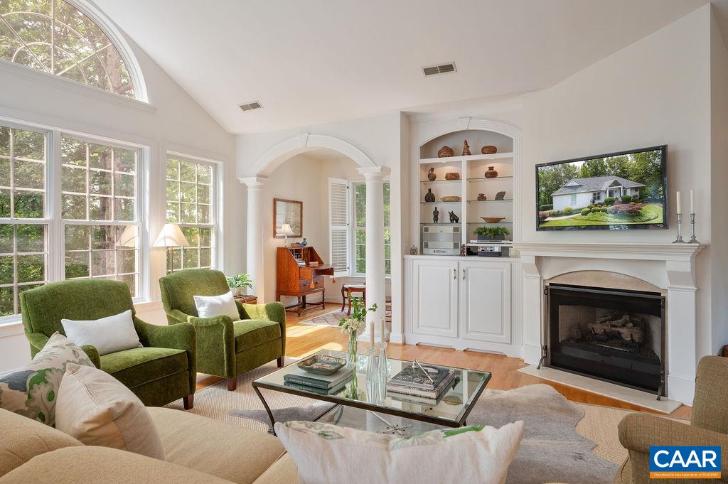 3515 Devon Pines Keswick, VA 22947 - Photo 17 of 68 a living room with furniture a flat screen tv and a fireplace