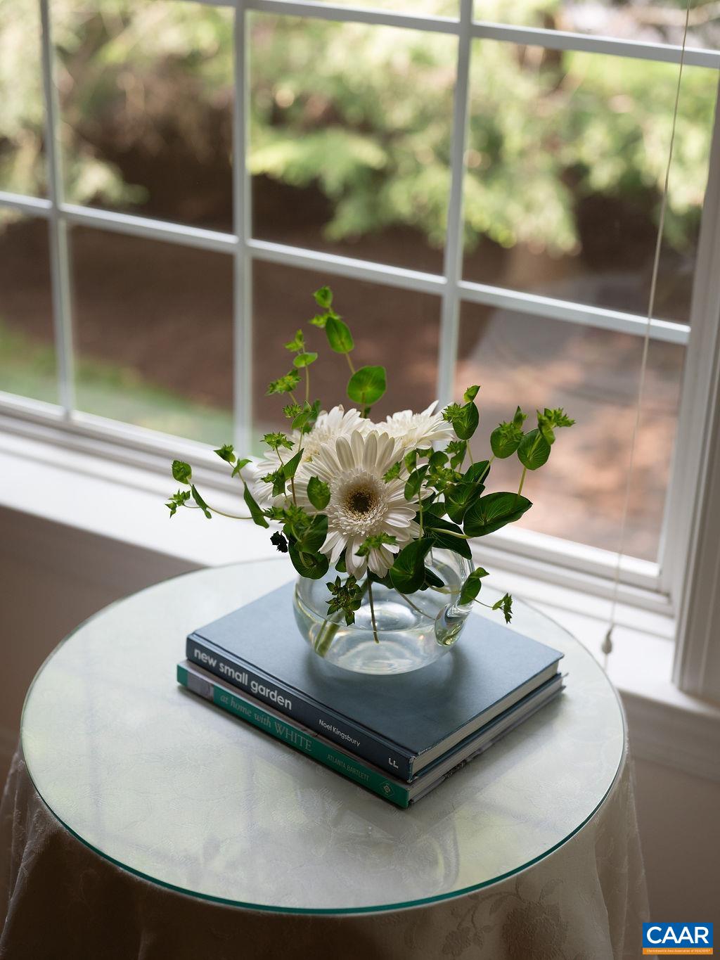 3515 Devon Pines Keswick, VA 22947 - Photo 36 of 68 a vase of flowers sitting on a table with a glass window