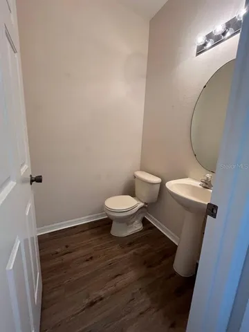 a white toilet sitting next to a bathroom sink