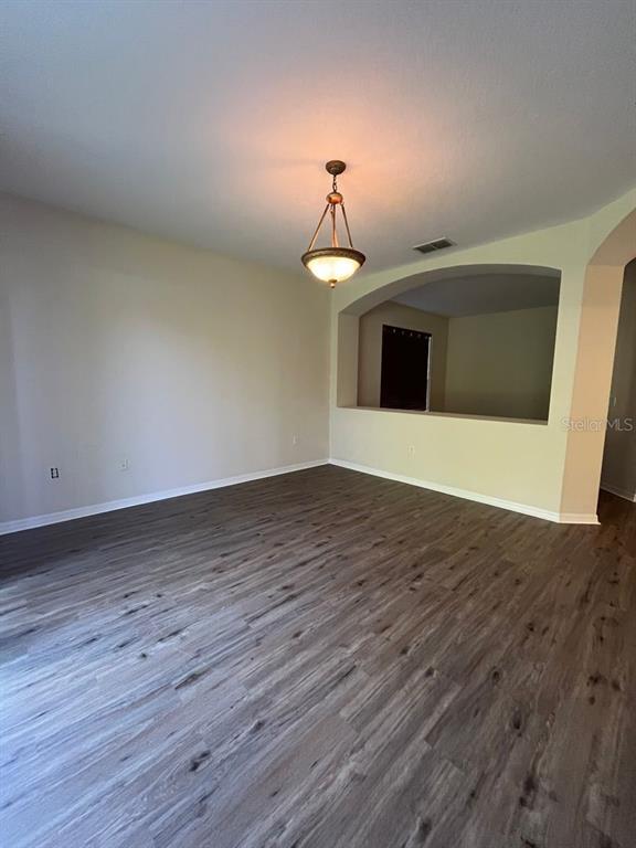 21 Whittingham Lane Palm Coast, FL 32164 - Photo 16 of 34 a view of a room with wooden floor and chandelier