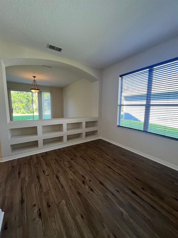 21 Whittingham Lane Palm Coast, FL 32164 - Photo 17 of 34 wooden floor in an empty room with a window