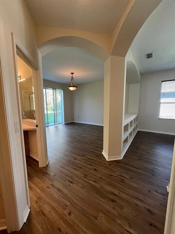 21 Whittingham Lane Palm Coast, FL 32164 - Photo 25 of 34 a view of a hallway with wooden floor and a living room