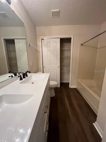 a bathroom with a sink a large mirror and a shower