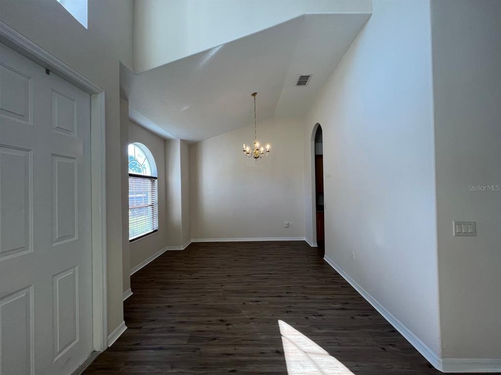 21 Whittingham Lane Palm Coast, FL 32164 - Photo 4 of 34 a view of a hallway with wooden floor and staircase