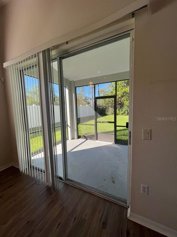21 Whittingham Lane Palm Coast, FL 32164 - Photo 9 of 34 a view of an empty room with wooden floor and a window