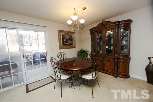 7717 Falcon Rest Circle, Unit 7717 Raleigh, NC 27615 - Photo 3 of 14 a dining room with furniture and window