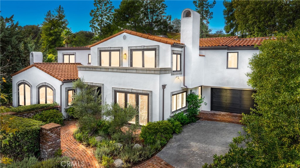 17153 Adlon Road Encino, CA 91436 - Photo 38 of 43 a front view of a house with garden