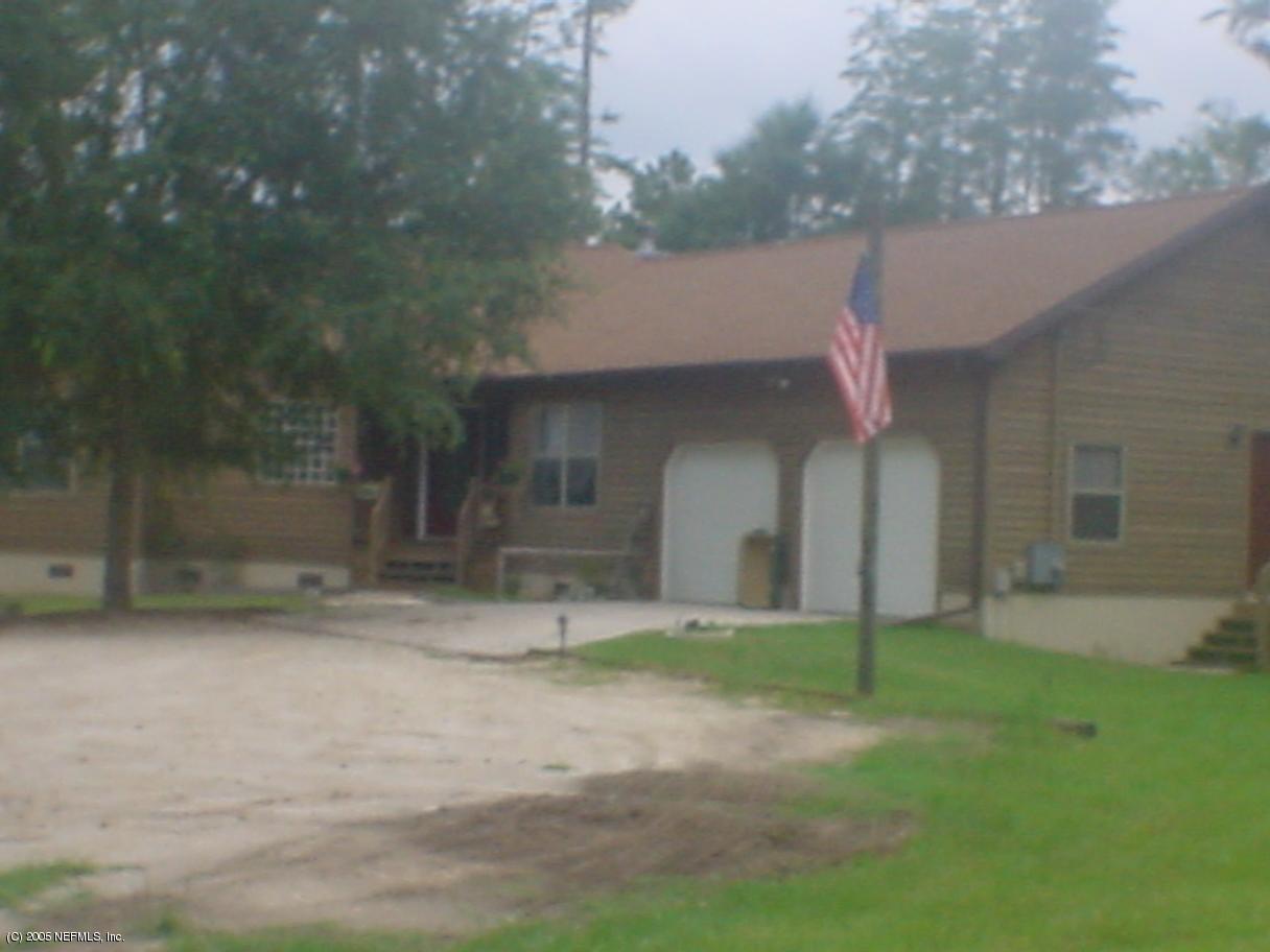 4985 Scaff Road St. Augustine, FL 32092 - Photo 1 of 2 a front view of a house with a yard and garage