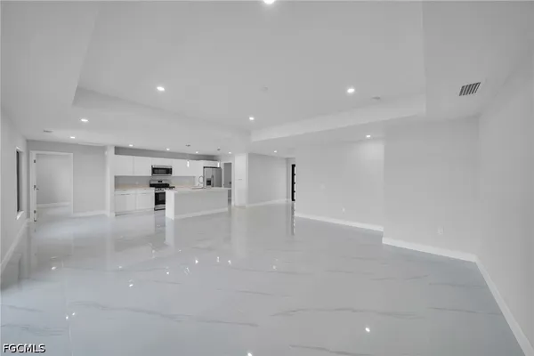 a view of kitchen and kitchen with refrigerator