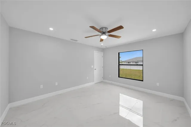 a view of room with window and ceiling fan