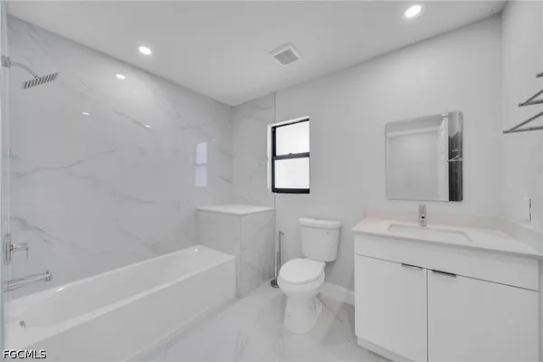 a bathroom with a toilet a sink and bathtub