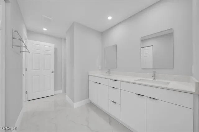 a bathroom with double sink and a mirror