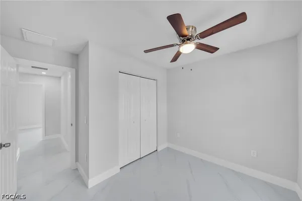 a wall with white walls and a ceiling fan
