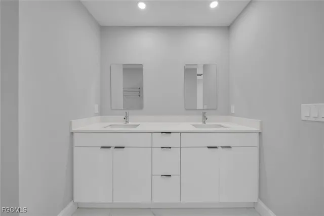 a bathroom with double sink and a mirror