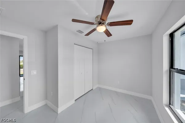 a view of room with a ceiling fan