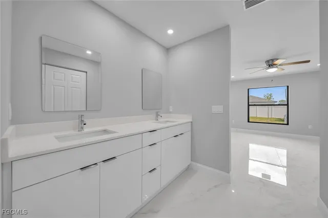 a bathroom with 2 sink and a mirror