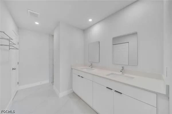 a bathroom with a double vanity sink mirror and
