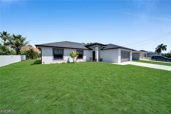 a front view of house with yard and green space