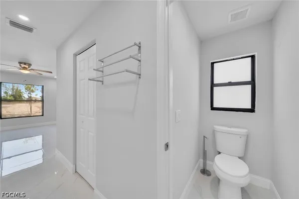 a white toilet sitting next to a bathroom sink