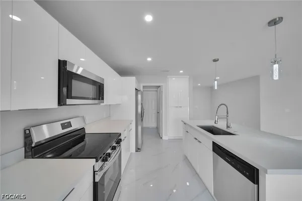 a kitchen with a sink stainless steel appliances and cabinets