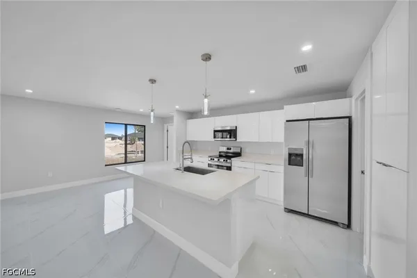 a kitchen with refrigerator and a sink