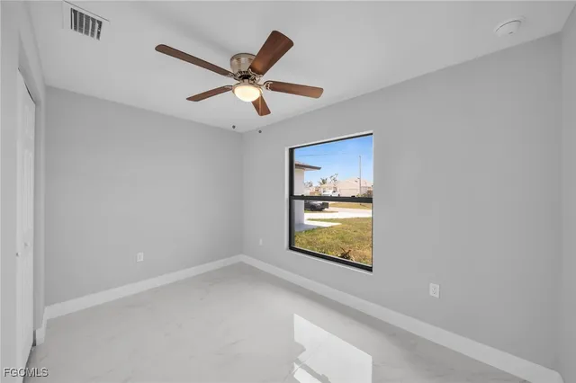 a view of an empty room and wooden floor
