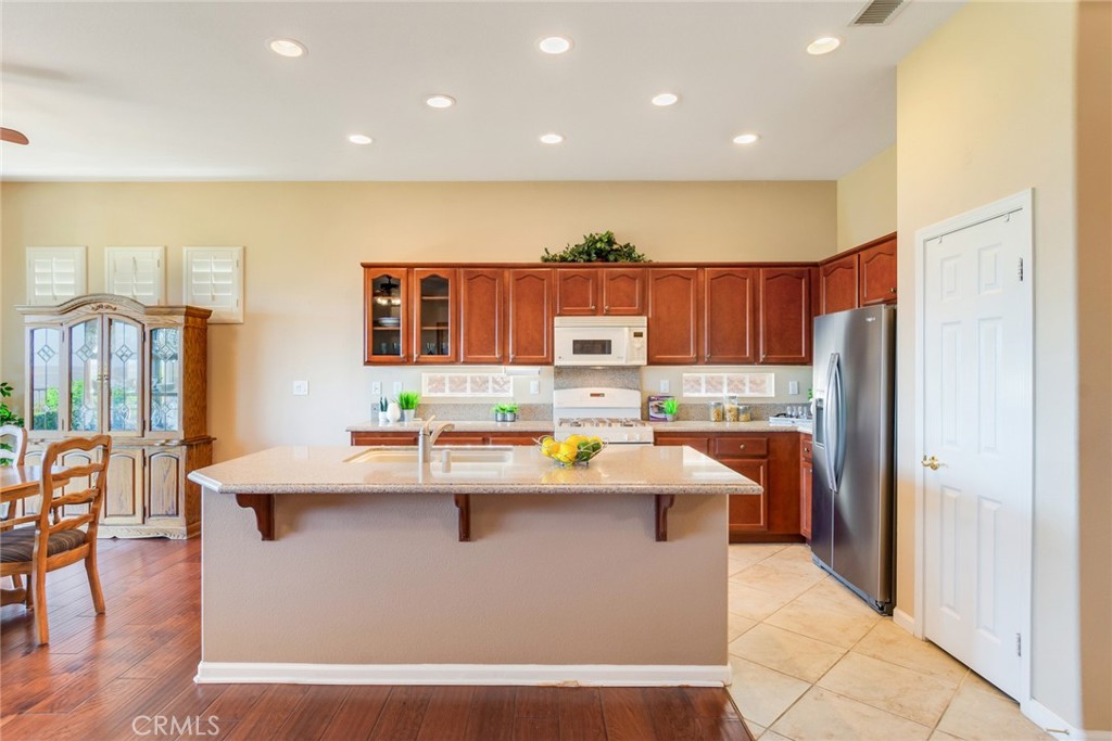24594 Hatton Lane Corona, CA 92883 - Photo 10 of 57 Bright Kitchen Is Well-Lit And Has Granite Counter Tops Throughout