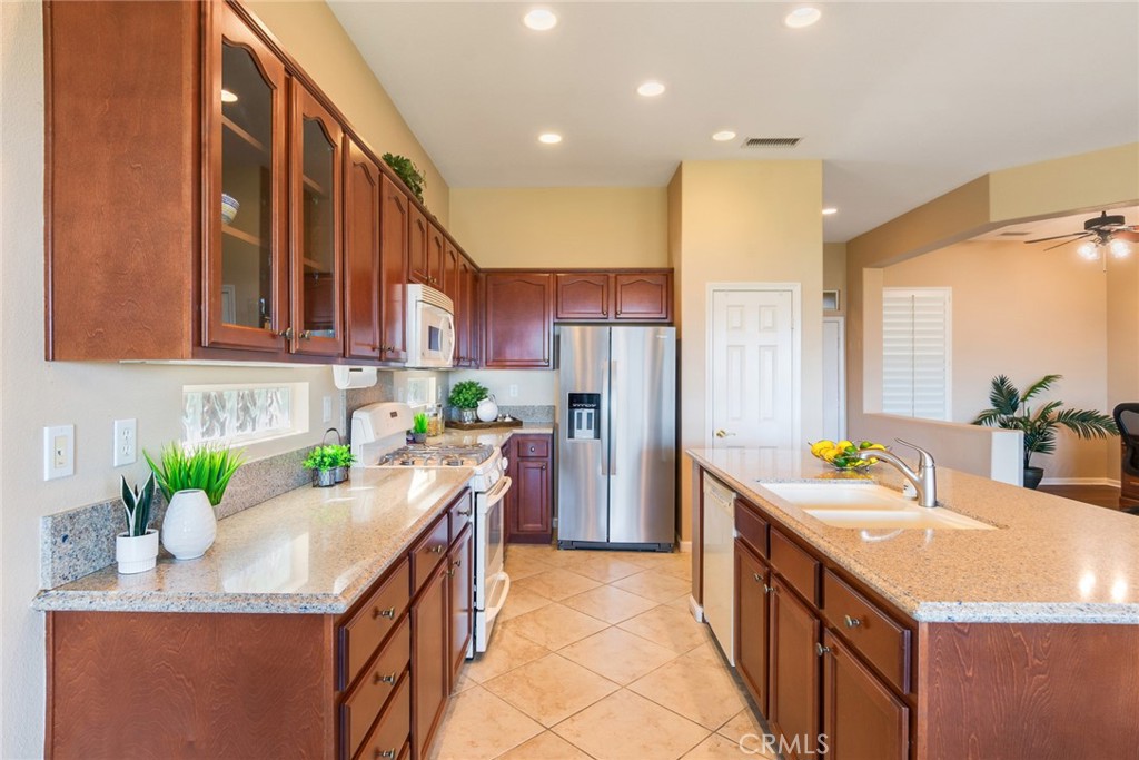 24594 Hatton Lane Corona, CA 92883 - Photo 11 of 57 a kitchen with a sink a stove and cabinets