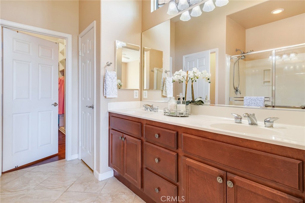 24594 Hatton Lane Corona, CA 92883 - Photo 20 of 57 a bathroom with a double vanity sink and a mirror