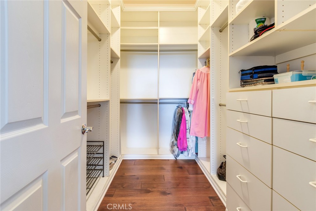 24594 Hatton Lane Corona, CA 92883 - Photo 21 of 57 a view of walk in closet with clothes and shoes