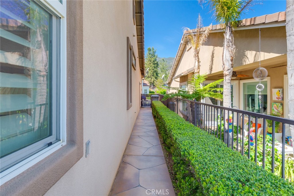 24594 Hatton Lane Corona, CA 92883 - Photo 22 of 57 a view of a brick house with a small yard