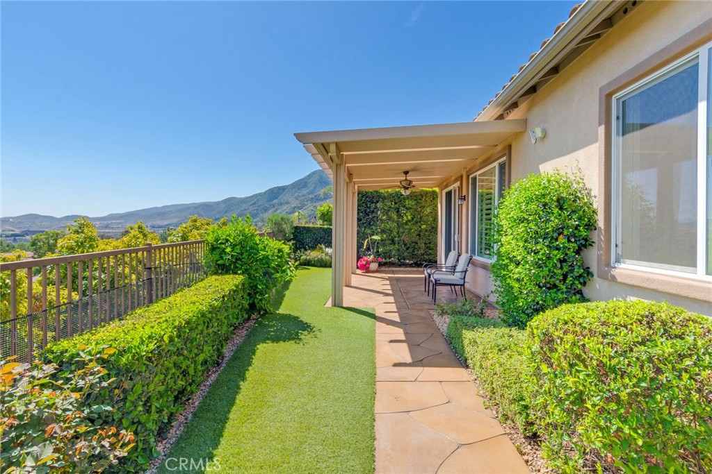 24594 Hatton Lane Corona, CA 92883 - Photo 25 of 57 a view of a patio with chairs and a table