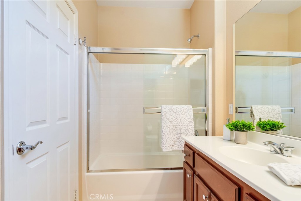 24594 Hatton Lane Corona, CA 92883 - Photo 4 of 57 a bathroom with a granite countertop shower and a sink