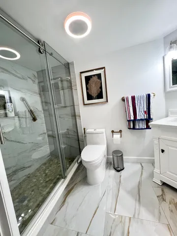 a bathroom with a toilet sink and shower