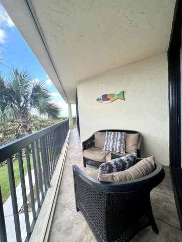a view of a two chairs in the balcony