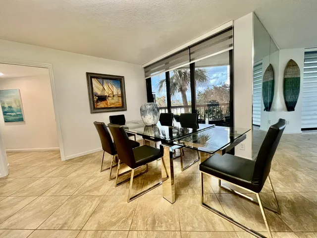 a view of a dining room with furniture and a window