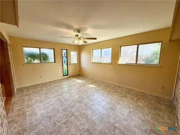 a view of an empty room with windows