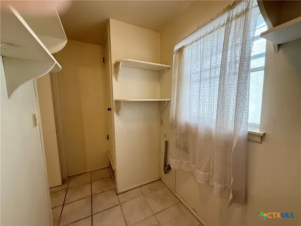 a bathroom with a shower and a glass door