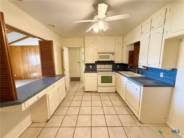 a kitchen with stainless steel appliances a stove a sink and a refrigerator