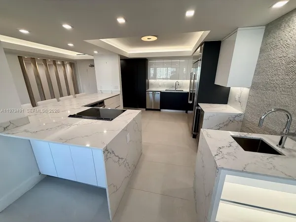 a kitchen with a sink and a refrigerator