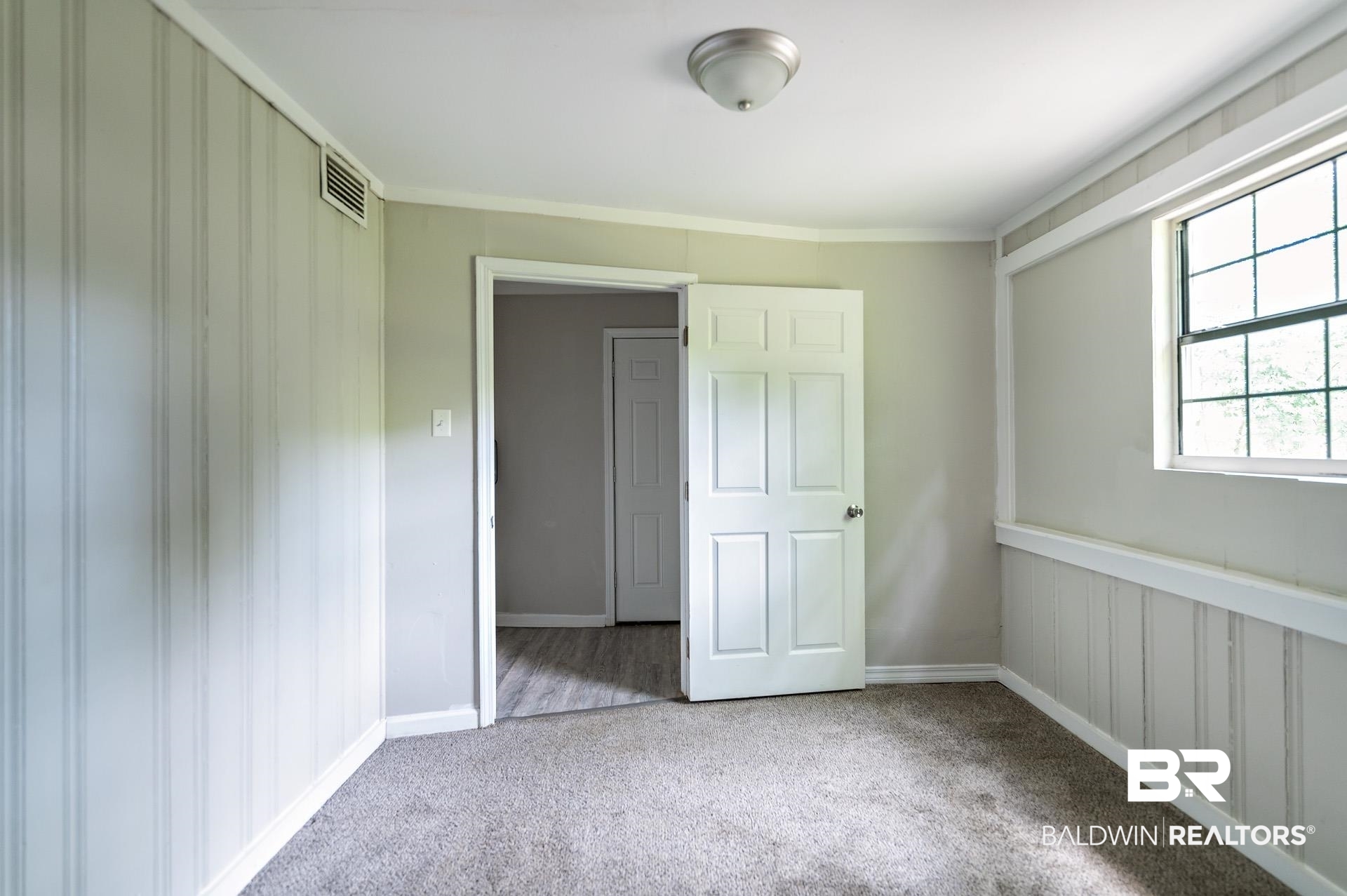 1869 Mott Drive West Mobile, AL 36617 - Photo 26 of 34 Unfurnished bedroom with baseboards, visible vents, and carpet