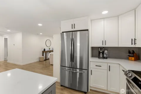a kitchen with stainless steel appliances a refrigerator sink and cabinets