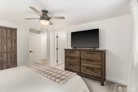 a room with a bed and a flat screen tv
