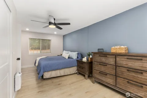 a bedroom with a bed and a chandelier