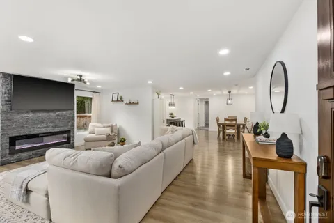 a living room with furniture a fireplace and a flat screen tv